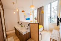 a bathroom with a sink and a bed at LOLA Boutique Hôtel - Bordeaux Centre in Bordeaux