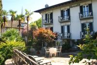 a hotel with a table and chairs in front of it at Hotel Villa Ruscello in Baveno