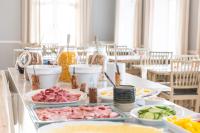 a table with plates of food on top of it at STF Undersvik Gårdshotell & Vandrarhem in Vallsta