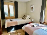 a bedroom with two beds and a window at The Castle, 10 Bedroom Chalet, Chamonix Centre in Chamonix