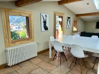 a dining room with a table and chairs and a window at The Castle, 10 Bedroom Chalet, Chamonix Centre in Chamonix