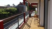 a balcony of a house with a view of a train at Les Voiles du Clipper T2 in Préfailles