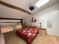 a bedroom with a large bed in a attic at Loft Saint-Jean in Monségur