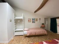 a bedroom with a bed and a book shelf at Loft Saint-Jean in Monségur