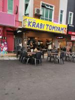 a restaurant with tables and chairs in front of a building at Iwan Ila Homestay in Batang Kali