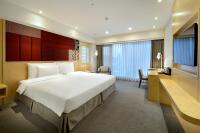 a hotel room with a large bed and a desk at Sonnien Hotel in Taipei