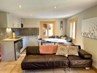 a living room with a couch and a kitchen at The Castle, 10 Bedroom Chalet, Chamonix Centre in Chamonix