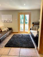 a living room with a couch and a rug at The Castle, 10 Bedroom Chalet, Chamonix Centre in Chamonix