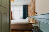 a hotel room with a bed and a window at Hotel Mercier in Amsterdam