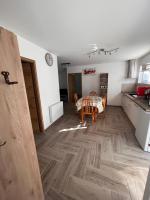 a kitchen and dining room with a wooden floor at Gîte chez Audrey et Pascal in Westhouse