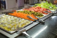 a buffet with many different types of food on at Cabañas Valle del Cabriel in Villatoya