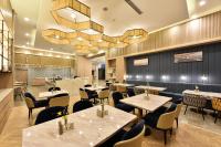 a restaurant with tables and chairs and a chandelier at Atour Hotel Beijing Yizhuang Mobile Silicon Valley in Daxing