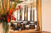 a mirror in a dining room with tables and chairs at Grand Hotel Karel V in Utrecht