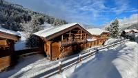a log cabin in the snow with a fence at Chalet La Mésange Boréale in Morzine