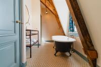 a bathroom with a claw foot tub and a sink at Hotel Mercier in Amsterdam
