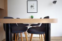 a dining room table with four chairs around it at FINESTATE Coliving Champs-Elysées in Paris