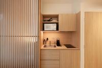 a small kitchen with a sink and a microwave at FINESTATE Coliving Champs-Elysées in Paris