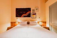 a bedroom with a large white bed with two pillows at Hotel Mercier in Amsterdam