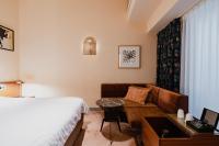 a hotel room with a bed and a couch at Hotel Mercier in Amsterdam