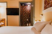 a bedroom with a white bed and a sliding glass door at Hotel Mercier in Amsterdam