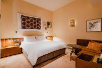 a hotel room with a bed and a couch at Hotel Mercier in Amsterdam