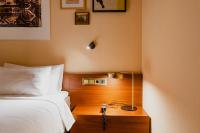 a bedroom with a bed and a table with a lamp at Hotel Mercier in Amsterdam