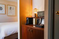 a hotel room with a bed and a room with a bed sqor at Hotel Mercier in Amsterdam