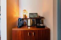 a wooden cabinet with a phone on top of it at Hotel Mercier in Amsterdam