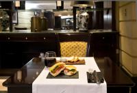 a table with a sandwich and a glass of wine at Amérian Mendoza in Mendoza