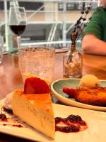 a table with two plates of food and a glass of wine at Hotel Indigo Madrid - Gran Vía by IHG in Madrid