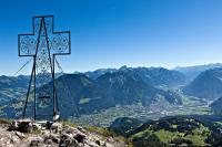 a cross on top of a mountain with a city at Haus Rätikon in Brand