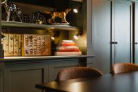 a table with chairs and books on a shelf at Hotel Mercier in Amsterdam