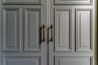 a white door with two handles on it at Hotel Mercier in Amsterdam