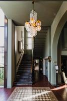 a hallway with a staircase with a chandelier at Hotel Mercier in Amsterdam