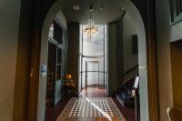 an arched hallway with a chandelier in a house at Hotel Mercier in Amsterdam