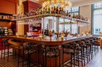 a bar in a restaurant with a bunch of bottles at Hotel Mercier in Amsterdam
