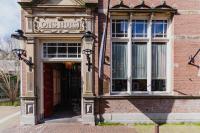 a brick building with a ones house sign on it at Hotel Mercier in Amsterdam