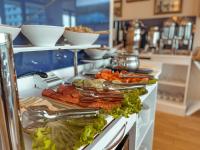 um bufê com muitos tipos diferentes de comida em um balcão em Batumi High floor em Batumi