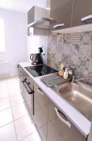 a kitchen with a stove top and a sink at Logement entier proche des châteaux - 1 à 6 Pers - in Barsac