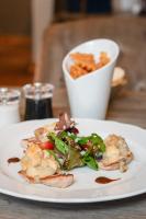 a plate of food with a salad and a drink at Hotel Schloss Rattey in Schönbeck