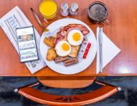 a plate of breakfast food with eggs and bacon at Great Southern Hotel Brisbane in Brisbane