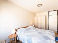 a bedroom with a blue and white bed and a table at Lilyta B403 4A apartment in De Haan near the sea in De Haan