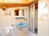 a bathroom with a blue sink and a mirror at Apartment in Bramberg am Wildkogel with balcony in Bramberg am Wildkogel