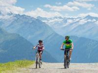 two people riding bikes on a mountain top at Apartment in Bramberg am Wildkogel with balcony in Bramberg am Wildkogel