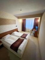A bed or beds in a room at Hotel Rila
