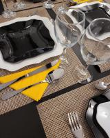 a table with a plate and a yellow napkin at Adac Boutique Hotel in Bucharest