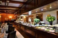a buffet line with plates of food in a restaurant at Valley Lodge & Spa in Magaliesburg