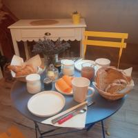 a blue table with food and bread on it at Au pied de la colline in Alembon