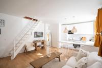 a white living room with a white couch and a table at Beautiful duplex on the outskirts of Paris - Welkeys in Levallois-Perret