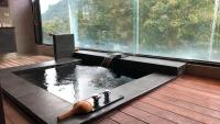 a jacuzzi tub in a room with a large window at Tangyue Resort in Tai&#39;an
